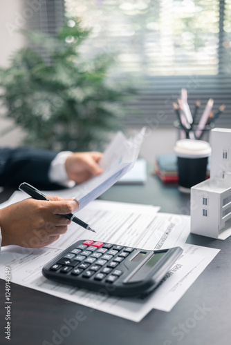 Finance bank tax expense accounting budget money businessman home for Business expense analysis saving use Financial calculate accountant close up calculator with graph chart hand write office desk