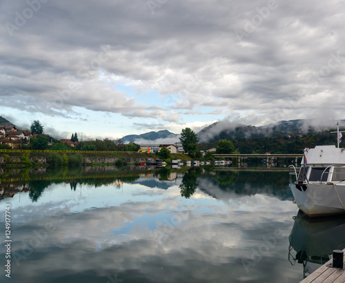 View of Visegrad, Serb Republic, Bosnia under grey autumn clouds reflecting in the river Drina photo