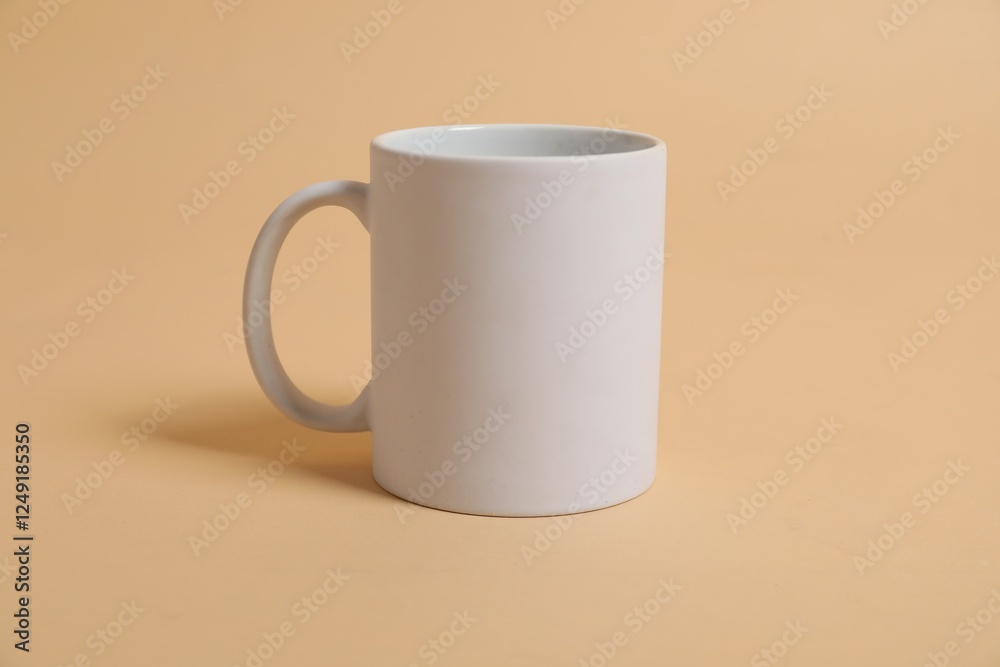 Blank white mug for branding on beige background. Mockup for design