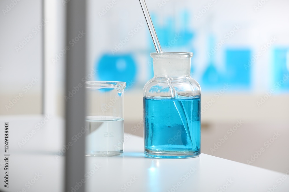 Laboratory glassware with liquid on shelf indoors Laboratory glassware with liquid on shelf indoors