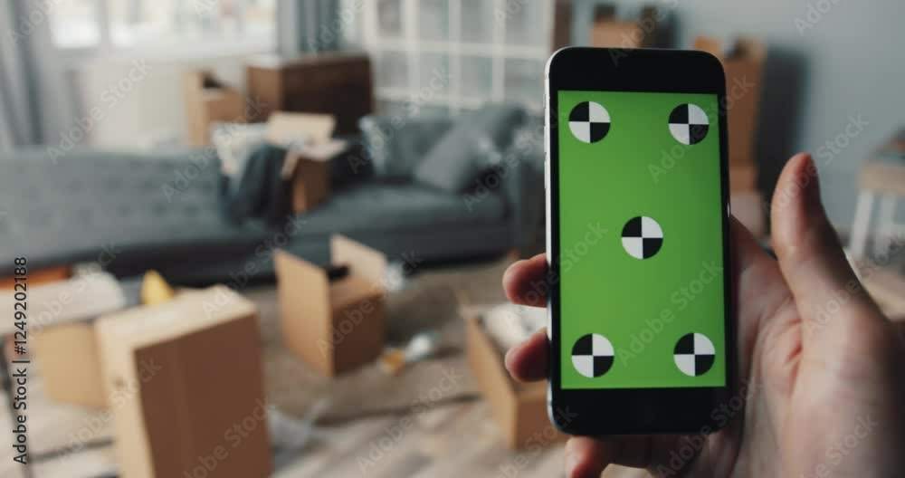 A cluttered living room filled with moving boxes, furniture, and disorganized items present