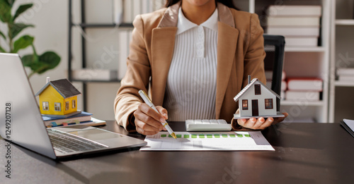 Female woman hand holding home model, investment small miniature white toy house. Mortgage property insurance dream moving home and real estate concept