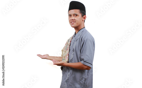 Asian Muslim man smiles and lets someone in and greets him sincerely