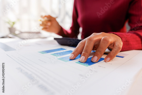 Business accountant or financial expert analyze business report graph and finance chart at corporate office. Concept of finance economy, banking business and stock market research.