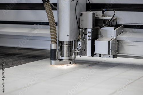 A high-tech CNC fabric cutting machine precisely cuts textile materials with automation. The advanced technology ensures accuracy and efficiency in industrial manufacturing and mass production