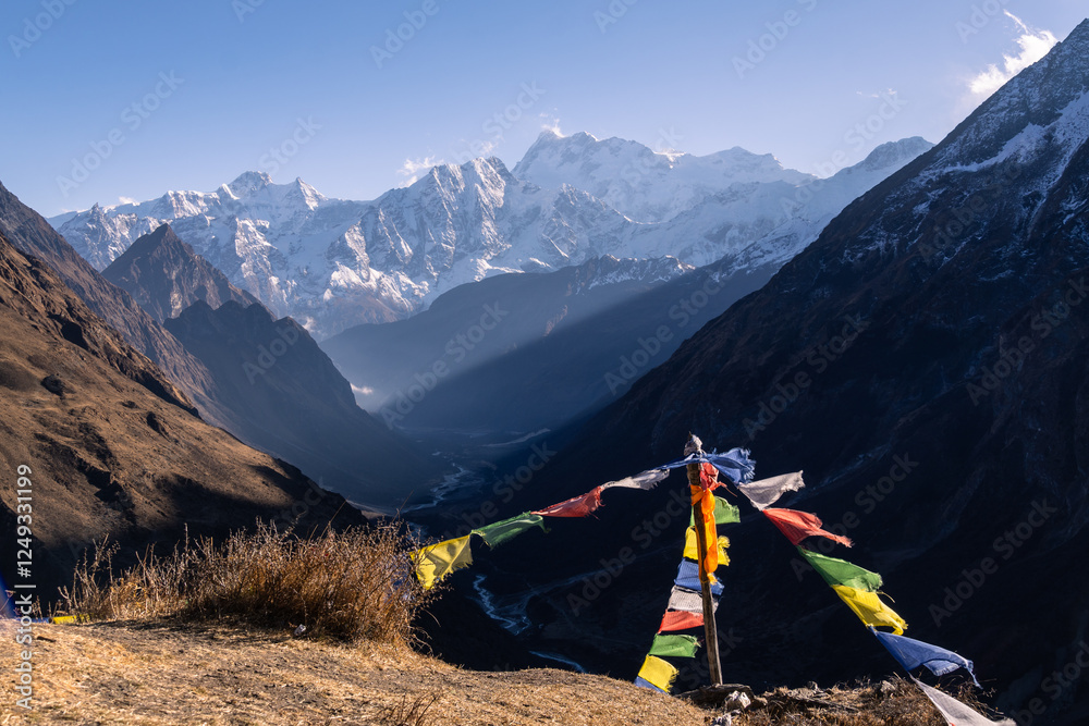 Samdo, Nepal: Tibetan buddhist prayer flags fly along the Manaslu circuit trek near above Samdo with the Himalchuli in the Himalayas in Nepal.