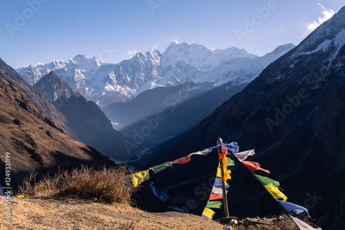 Obraz na płótnie Samdo, Nepal: Tibetan buddhist prayer flags fly along the Manaslu circuit trek near above Samdo with the Himalchuli in the Himalayas in Nepal. w salonie
