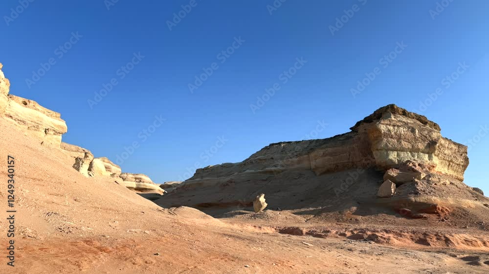 Golden cliffs with marine fossils exposed by erosion, rugged textures shaped by erosion, ancient marine remains embedded in cliffs, warm sunlight highlighting geological layers arid terrain stretching Golden cliffs with marine fossils exposed by erosion, rugged textures shaped by erosion, ancient marine remains embedded in cliffs, warm sunlight highlighting geological layers arid terrain stretching