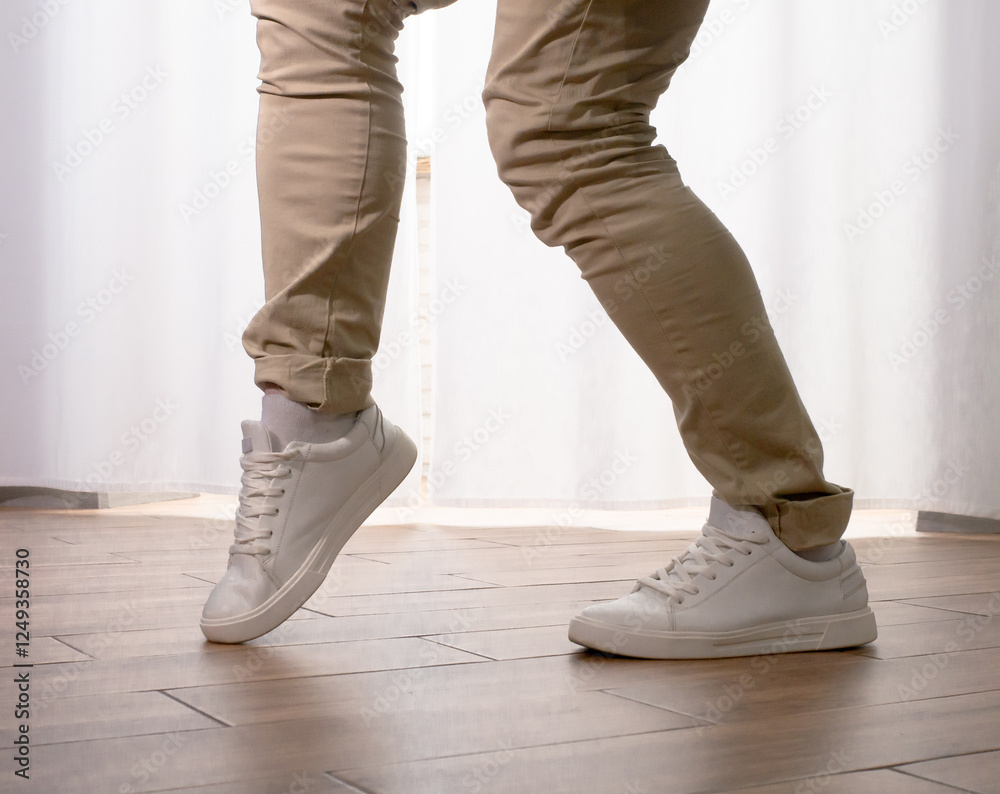 Young guy dancer in motion in a pose. A man performs a modern dance in casual clothes. Young guy dancer in motion in a pose. A man performs a modern dance in casual clothes.