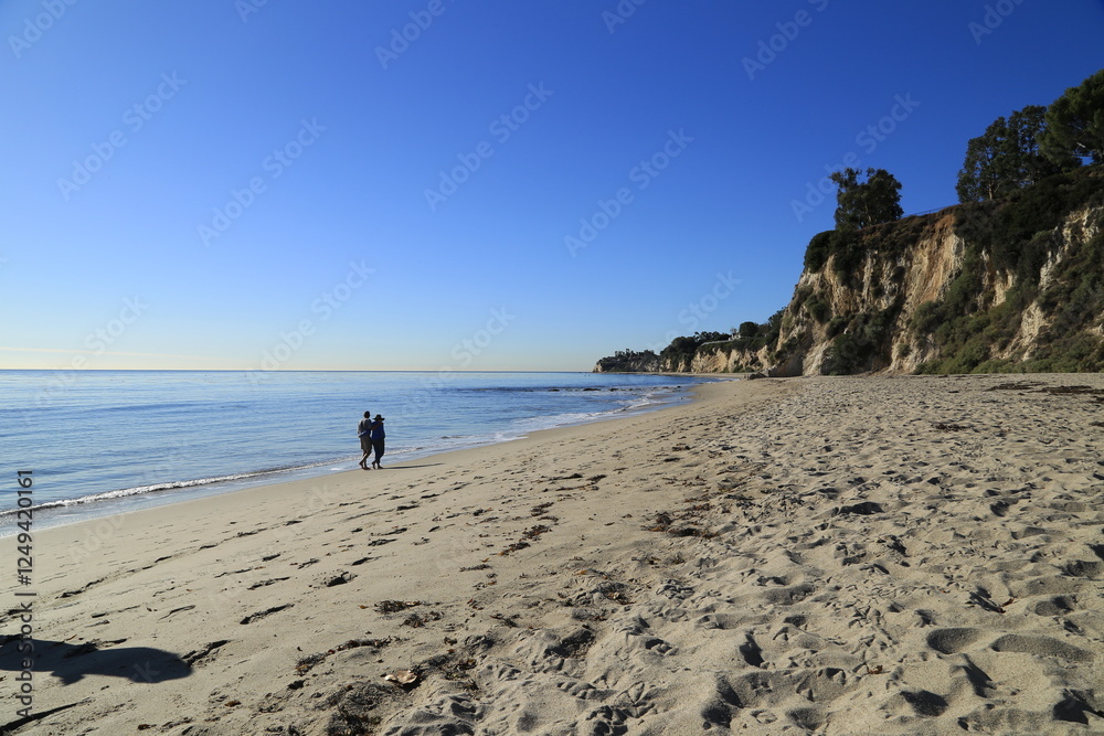 Couple Walking on the Beach Along Highway 1, California Couple Walking on the Beach Along Highway 1, California