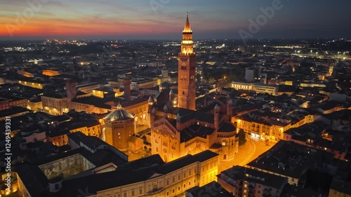 Evening after sunset aerial view of Cremona, Lombardy, Italy. Stunning nighttime view of Cremona showcasing illuminated architecture and city landscape at dusk