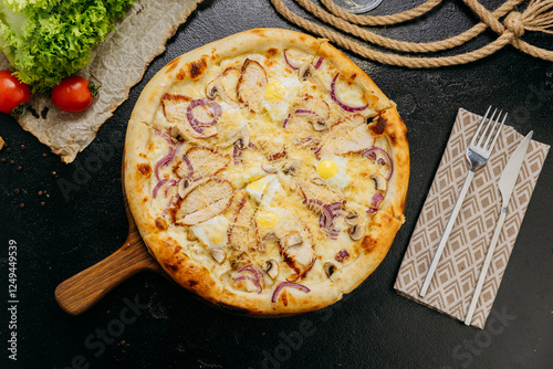Gourmet pizza with grilled chicken, mushrooms, red onion, quail eggs, and parmesan