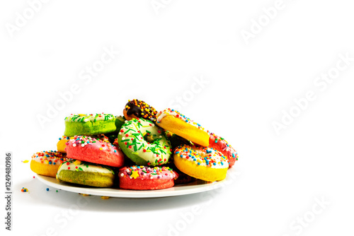 Colorful donuts on a white plate on a white background