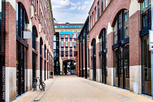 A perspective view of Waagstraat in Groningen, featuring modern brick architecture with arched windows and storefronts. Netherlands photo