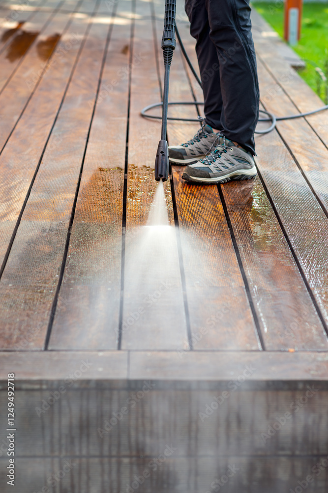 cleaning terrace with a power washer - high water pressure cleaner on wooden terrace surface cleaning terrace with a power washer - high water pressure cleaner on wooden terrace surface