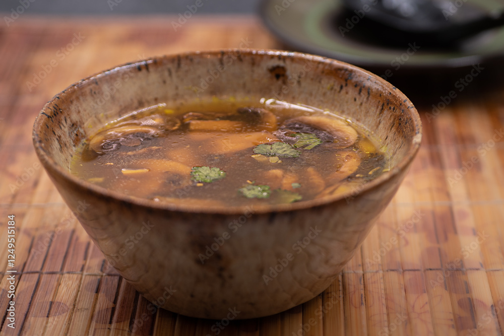 Ginger garlic soup with mushrooms in traditional Asian bowl Ginger garlic soup with mushrooms in traditional Asian bowl
