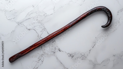 Wooden walking stick on marble background