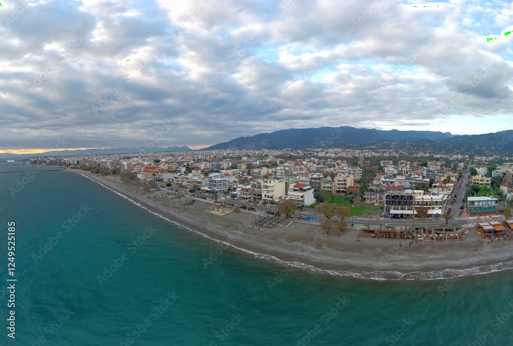 Fototapeta premium Panoramic view of the coast and city of Kalamata in Peloponnese, Greece, at sunset.