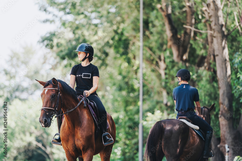 Two riders enjoy horseback riding through a scenic forest. The serene environment is perfect for equestrian training and relaxation amidst nature's beauty. Two riders enjoy horseback riding through a scenic forest. The serene environment is perfect for equestrian training and relaxation amidst nature's beauty.