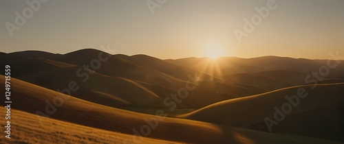 A dynamic closeup of a golden sunrise casting soft light over rolling hills each curve and shadow creating a picturesque landscape photo