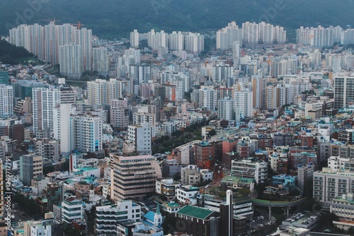 Aerial View of Dense Urban Skyline of Busan, South Korea, Featuring High-Rise Buildings and Residential Apartments