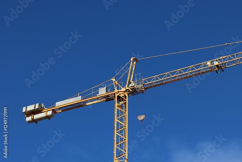 Tower Crane at Construction Site Against Clear Blue Sky