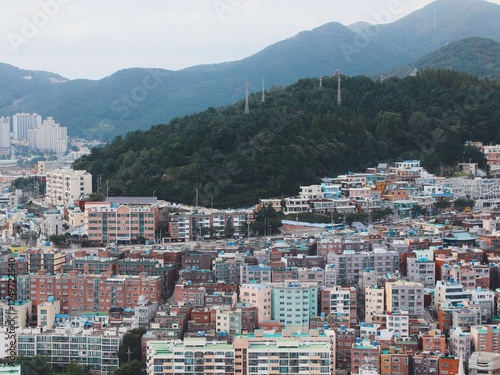 Aerial View of Dense Urban Skyline of Busan, South Korea, Featuring High-Rise Buildings and Residential Apartments