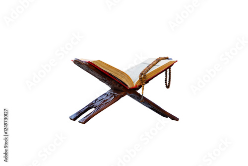 A close-up shot of an open Quran on a traditional wooden stand  with a string of prayer beads laid on top. The image is set against a plain png background, highlighting the Quran and prayer