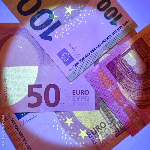 Checking banknotes with ultraviolet. Euro currency protected from ultraviolet radiation. Euro in ultraviolet light.