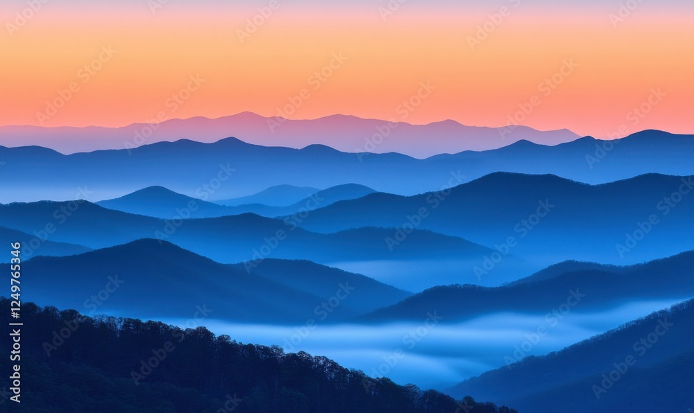 Obraz premium Misty mountain range at sunrise, with soft hues of orange and pink blending into the cool blue sky, creating a tranquil and breathtaking view