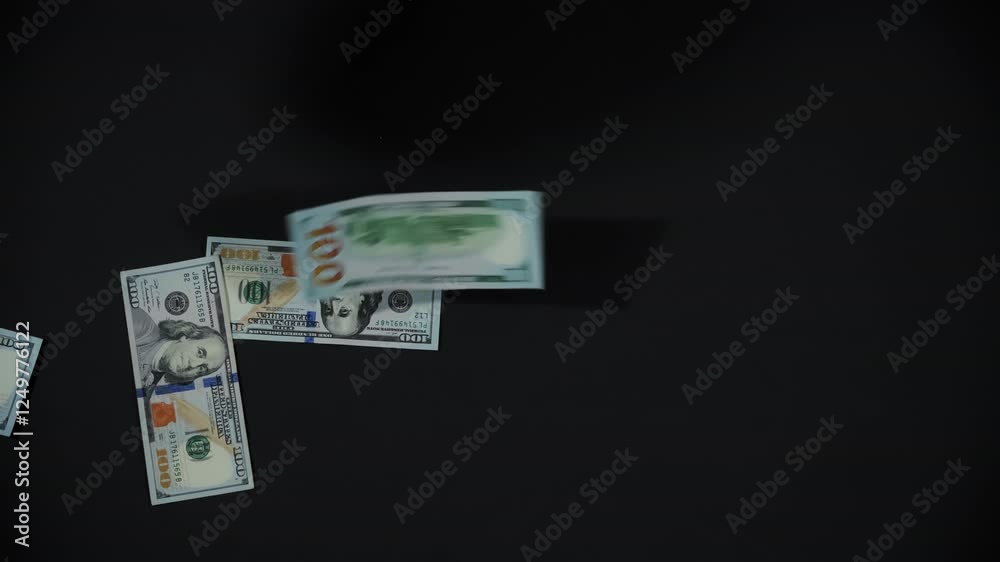 American hundred dollars banknotes falling on dark background. One hundred dollar bills. Cash money on dark background. American hundred dollars banknotes falling on dark background. One hundred dollar bills. Cash money on dark background.