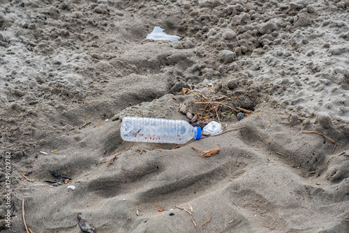 Wallpaper Mural A bottle of water is laying on the sand Torontodigital.ca