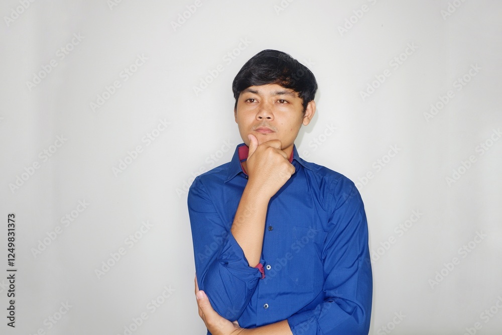 Asian Indonesian man wearing a plain blue shirt on a white background with happy expressions in various styles by expressing his hands Asian Indonesian man wearing a plain blue shirt on a white background with happy expressions in various styles by expressing his hands