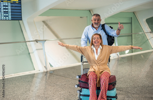 Happy senior couple enjoying their vacation at the airport photo