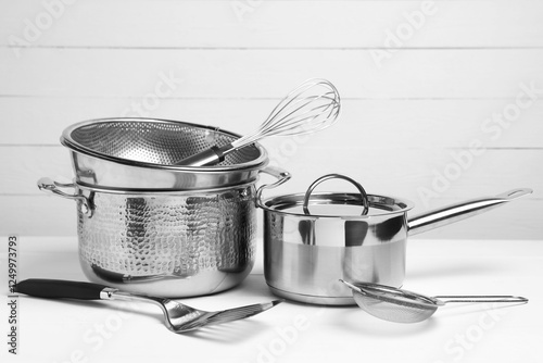 Dishware and cooking utensils on white table