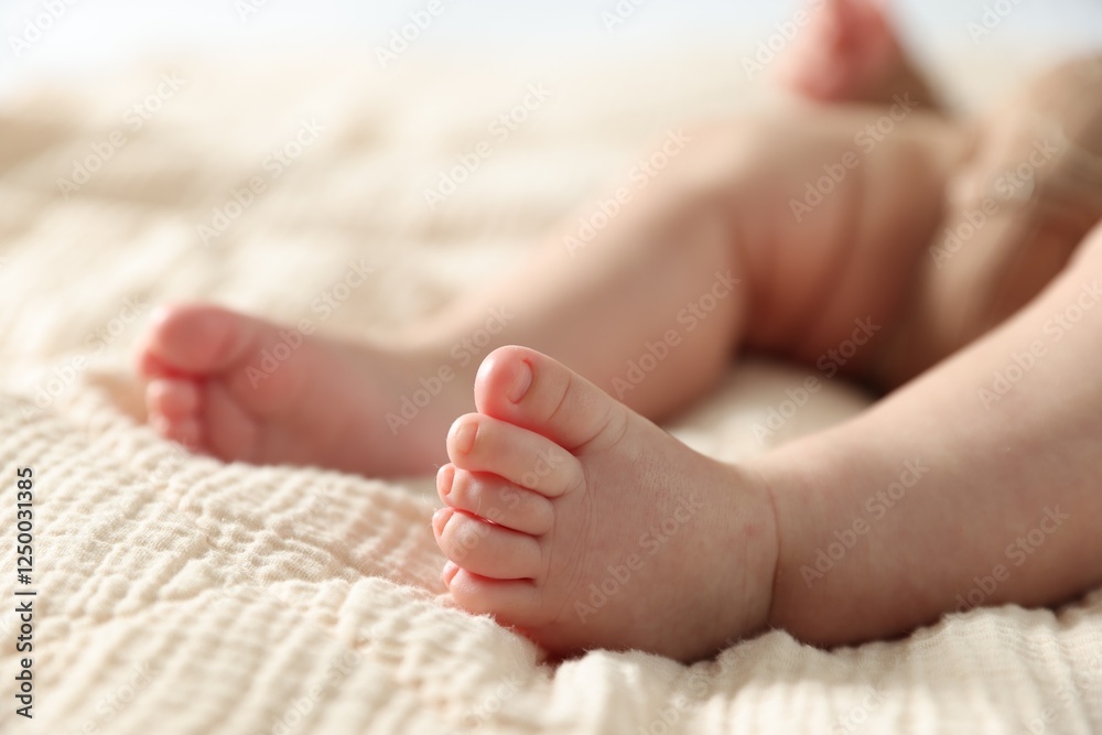 Little baby lying on bed indoors, closeup Little baby lying on bed indoors, closeup