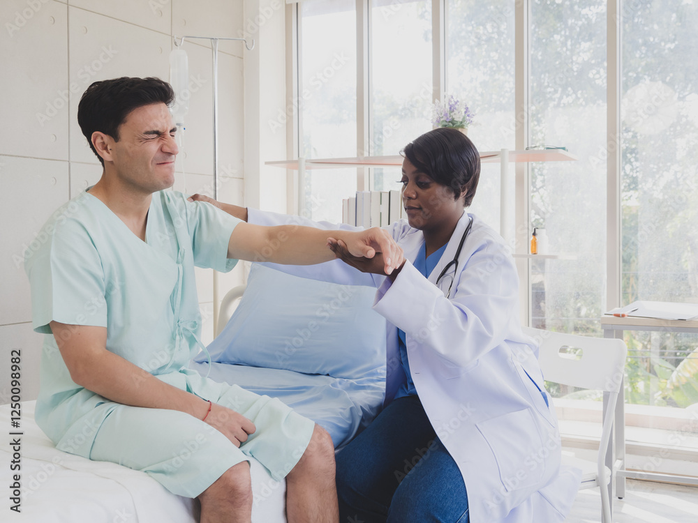 Patient caucasian man with woman doctor nurse black people carer physical therapist two person sit talk helping support give advice and holding hand arm inside clinic hospital indoor room service. Patient caucasian man with woman doctor nurse black people carer physical therapist two person sit talk helping support give advice and holding hand arm inside clinic hospital indoor room service.