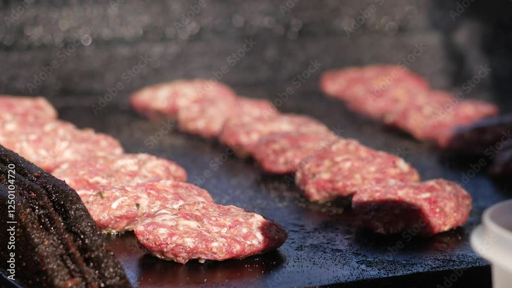 Grilling fresh beef patties at a summer cookout with friends