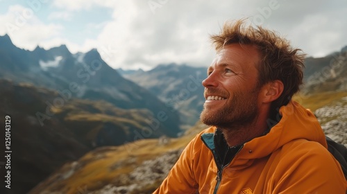 A cheerful man with a wide smile, gazing out over the mountains from a scenic lookout point, enjoying the fresh air and breathtaking surroundings