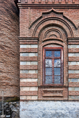 The stunning exterior of the Omar Efendi Mosque showcases the unique brickwork, arched window, and detailed design elements that reflect the architectural heritage of Shaki, Azerbaijan photo