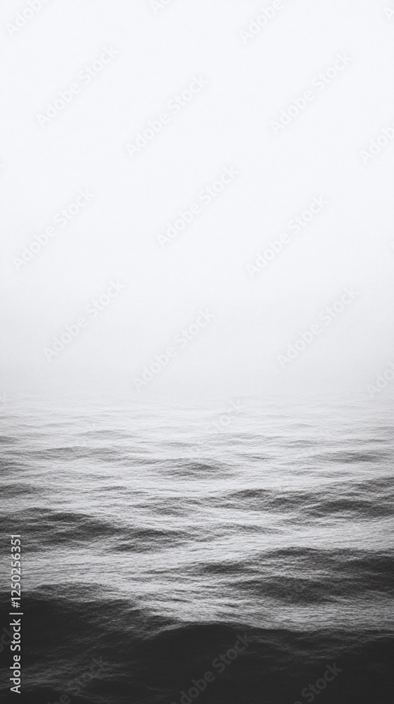 Fototapeta premium Monochromatic Sea Waves: A Serene Coastal View - Phone Wallpaper