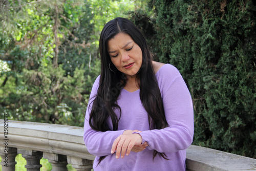 40 year old Latina woman suffers from hand and wrist pain due to arthritis injury or carpal tunnel syndrome