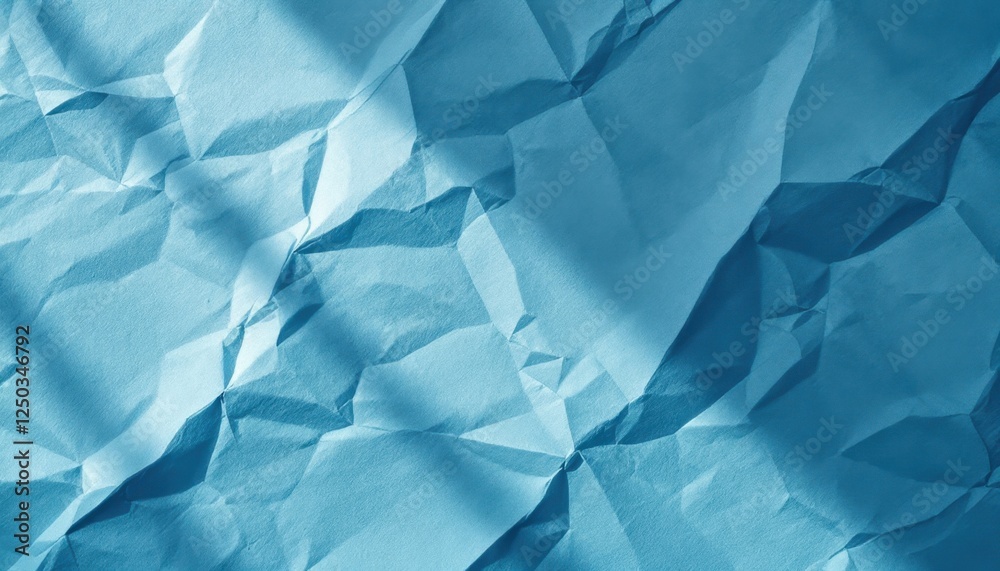 Obraz premium Crinkled blue paper texture with geometric fold patterns