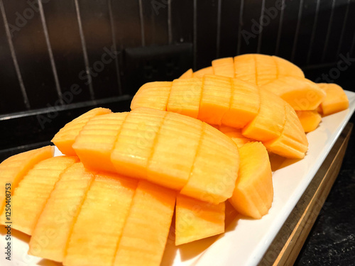 Sliced Cantaloupe on a plate buffet in hotel.