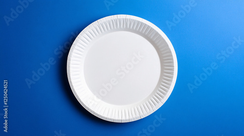 white paper plate on a blue background  minimalist table setting photography