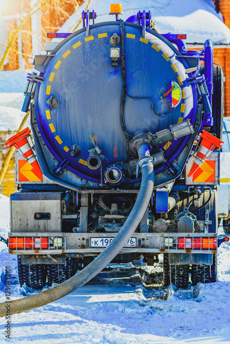 Sewage Tank truck. Sewer pumping machine. Septic truck. Pumping out sewage from a septic tank. Septic tank service. Close-up of a sewer machine with a hose near the house.