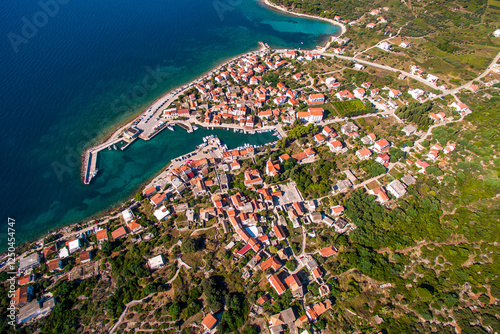 Top Down Aerial View of Sucuraj Harbor and Historic Village on Hvar Island, Croatia. Vibrant Mediterranean Architecture and Turquoise Waters photo