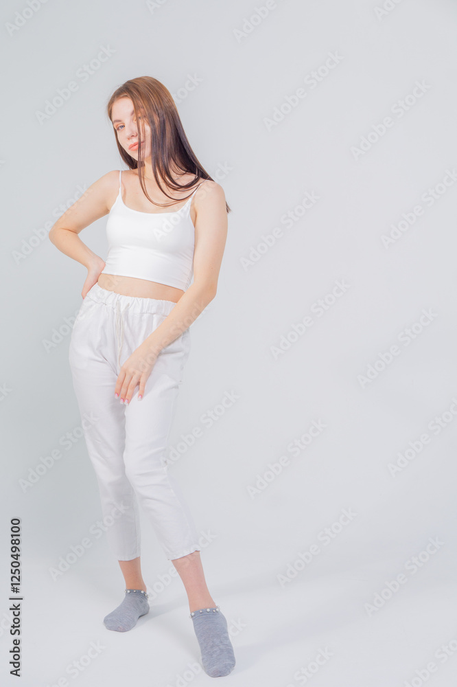 Cute young brunette standing on a white background. Copyspace Cute young brunette standing on a white background. Copyspace