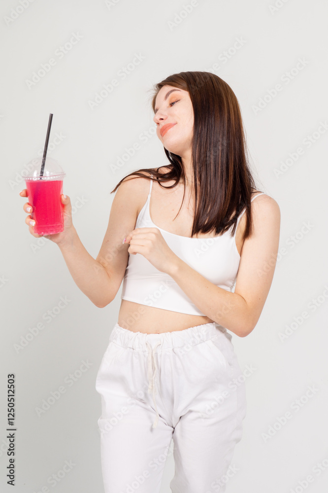 Chest portrait of a young woman with a cocktail on white background Chest portrait of a young woman with a cocktail on white background