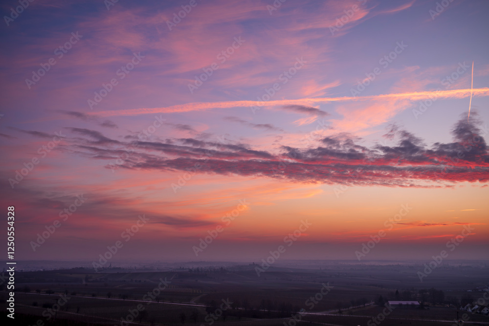 pink sunrise clouds over a village pink sunrise clouds over a village